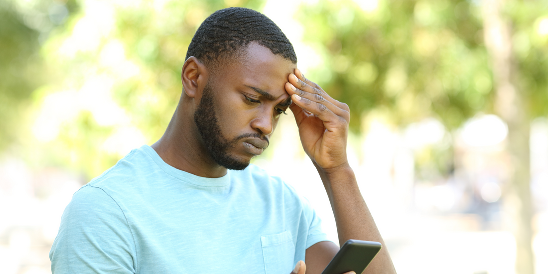 a man wary looking at his phone Quit Hero